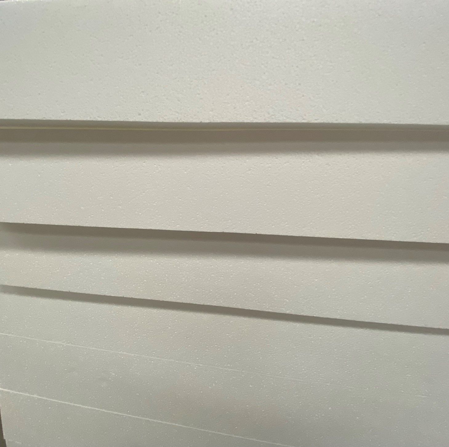 A close up of a white wall with a few lines on it