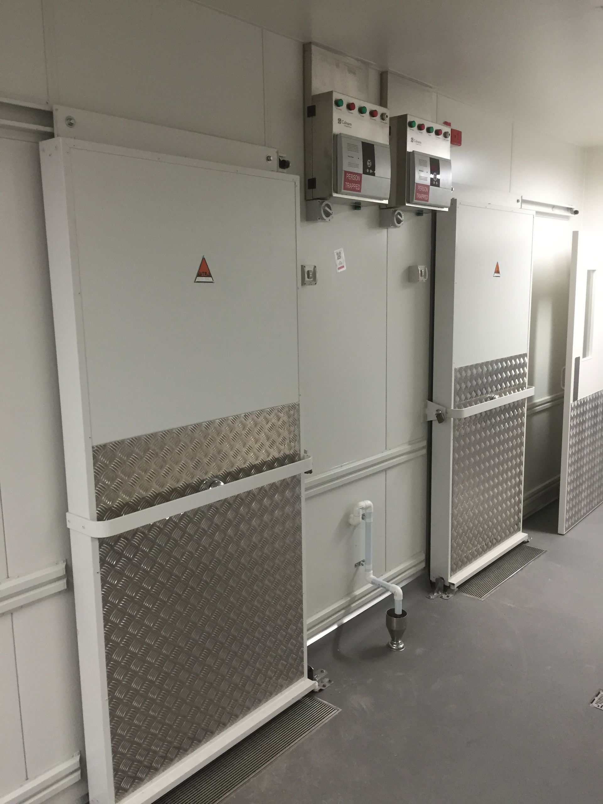 A room with a lot of sliding doors on the wall.