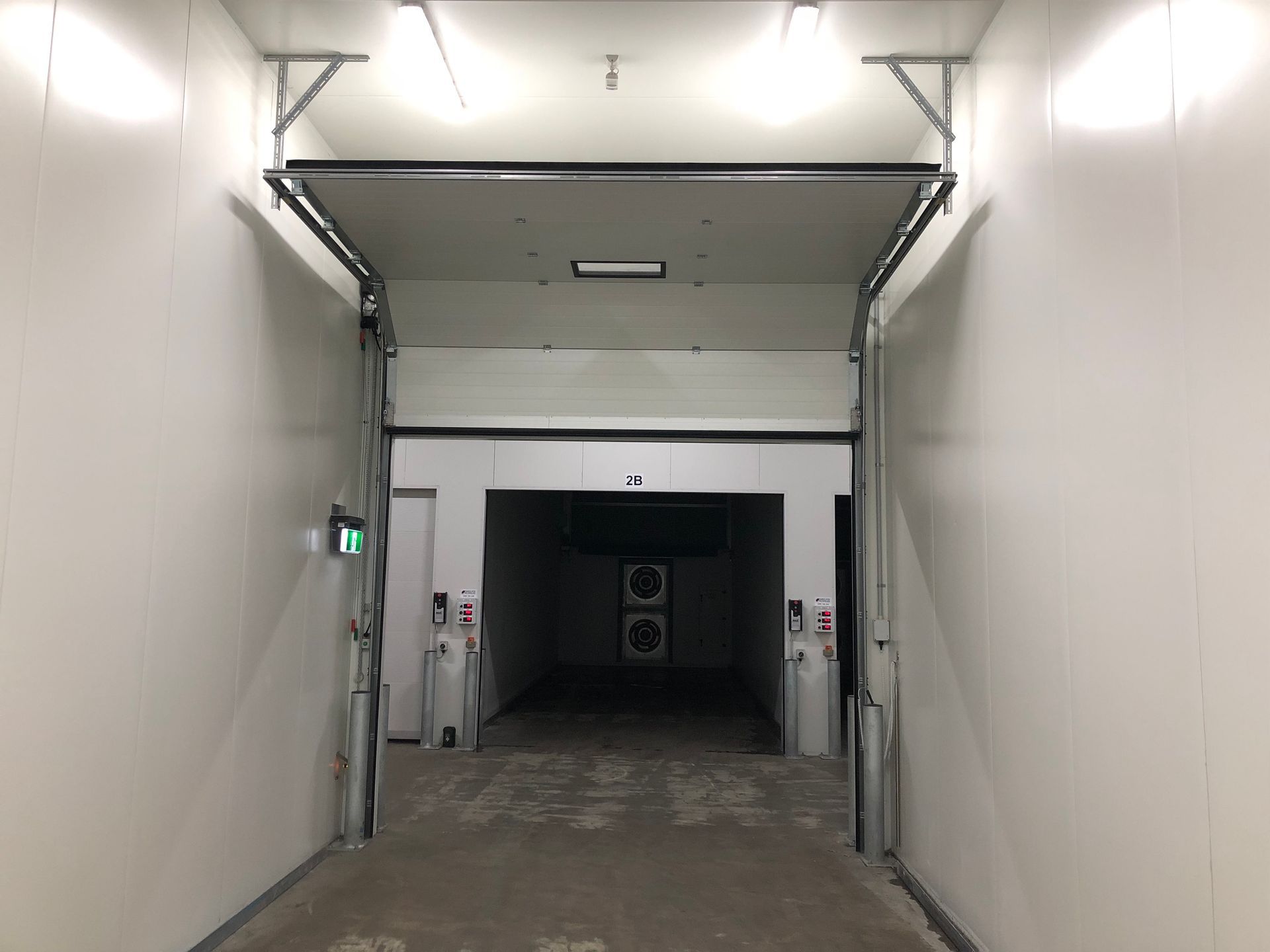 A very long hallway with a door that is open