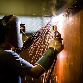 Man in protective goggles carrying out welding work