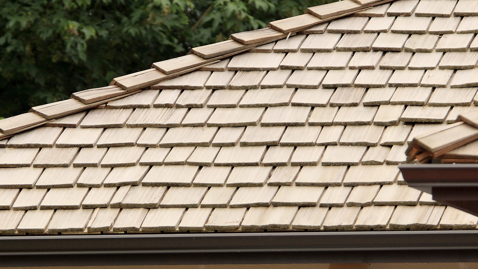 A close up of a wooden roof with shingles