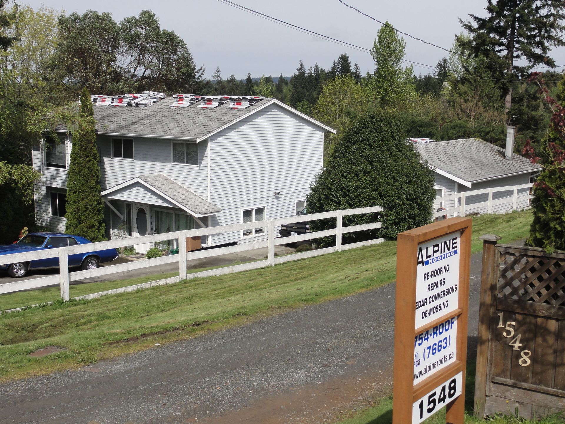 A house with a fence and a sign that says 1548