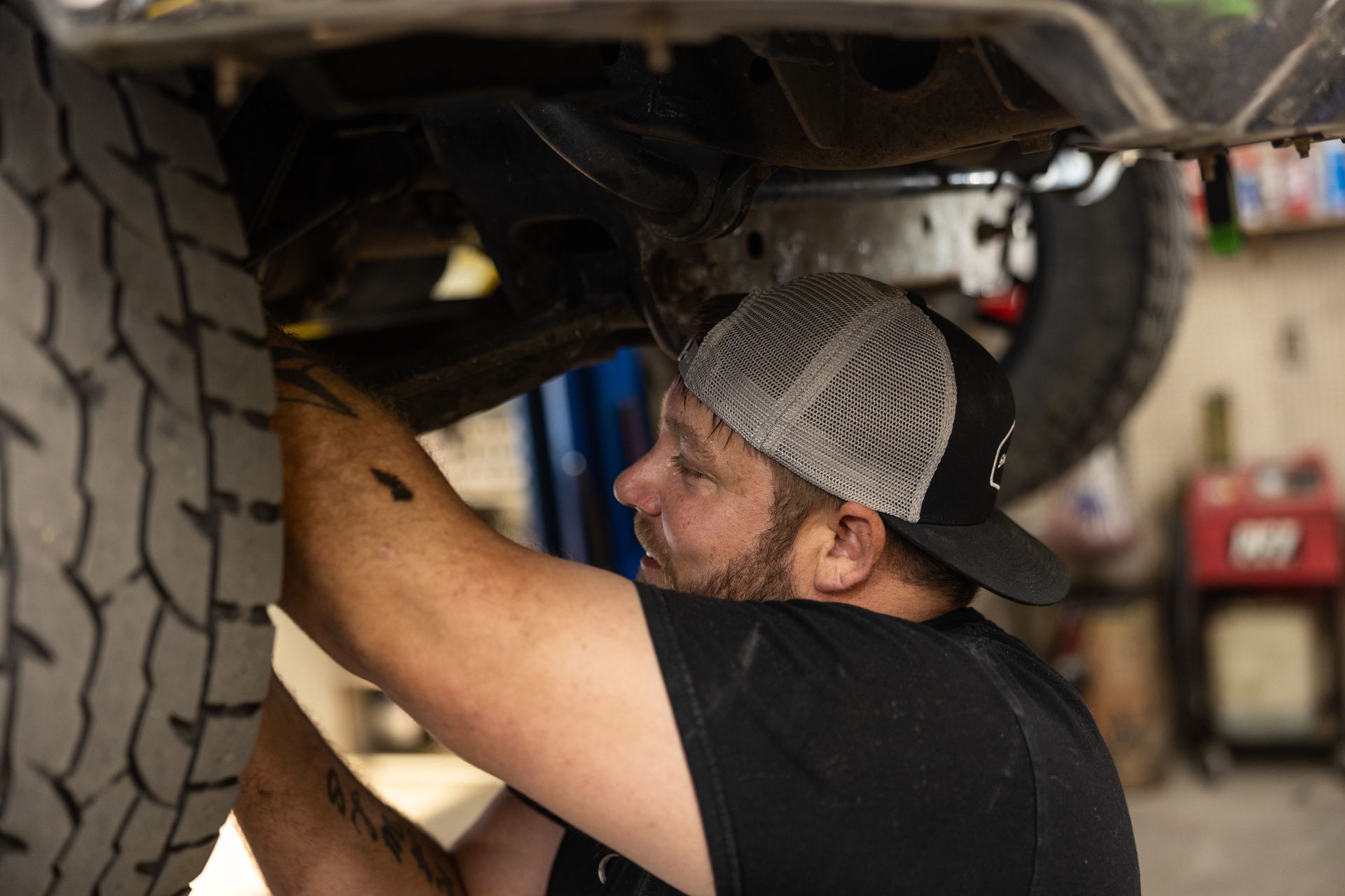 Mechanic under a vehicle | Pat's Auto Repair & Towing