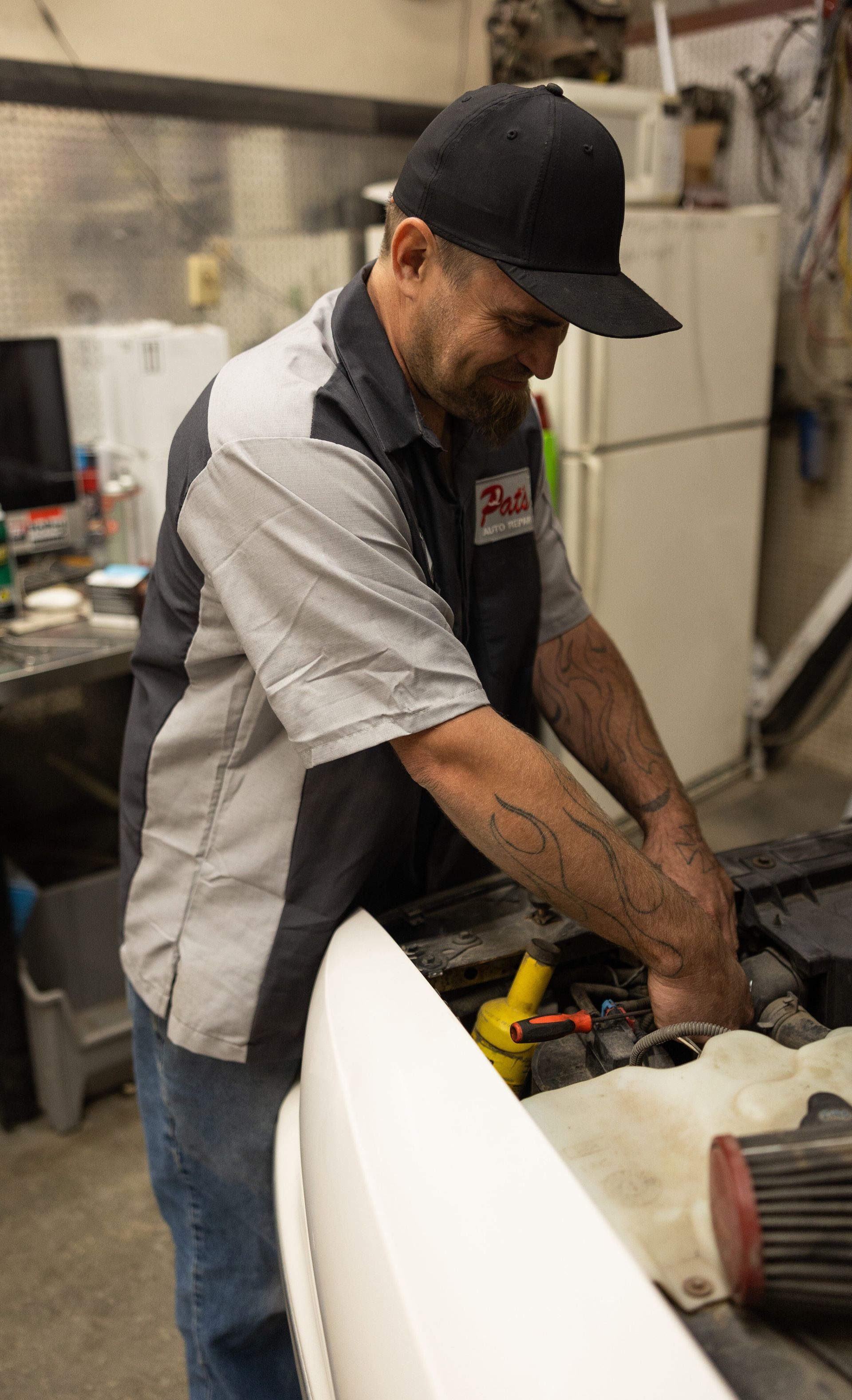 Mechanic works on a car engine | Pat's Auto Repair & Towing