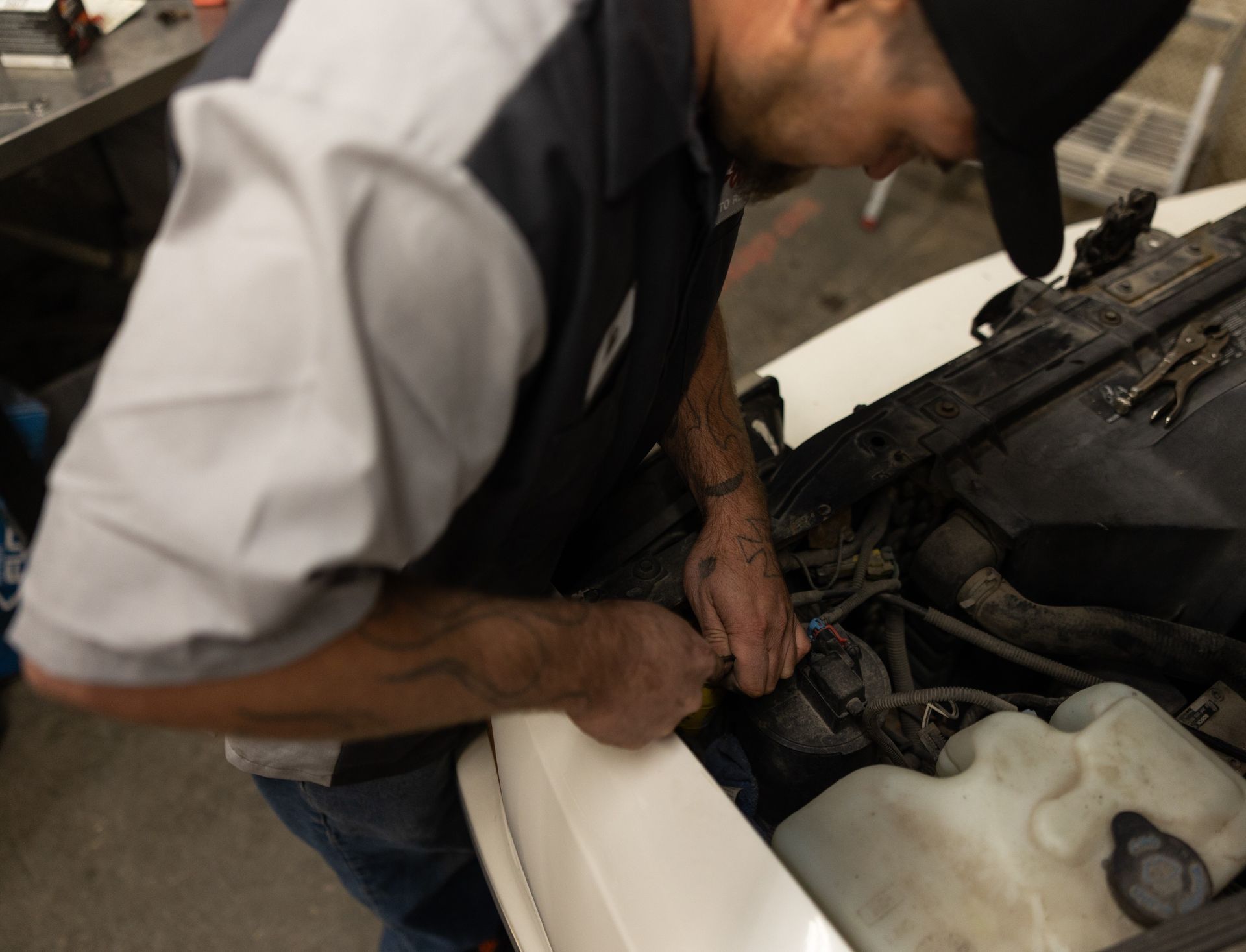 Mechanic working on a car engine | Pat's Auto Repair & Towing