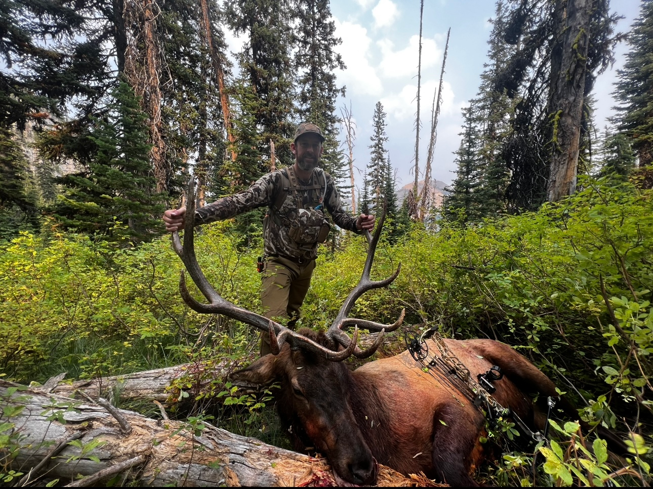 Man holding antlers of elk