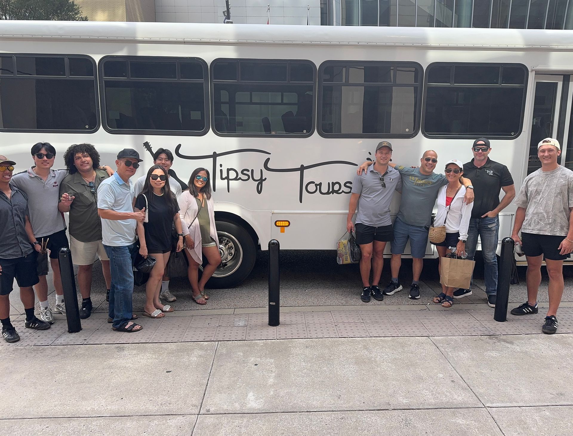 Group of people pose in front of a white 