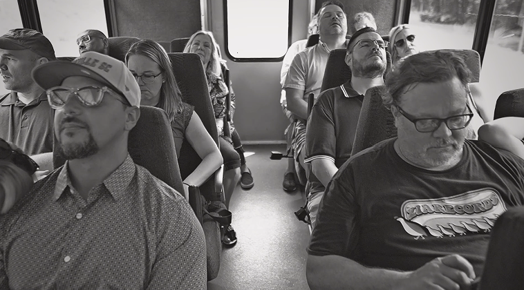 A group of people are sitting on a bus.