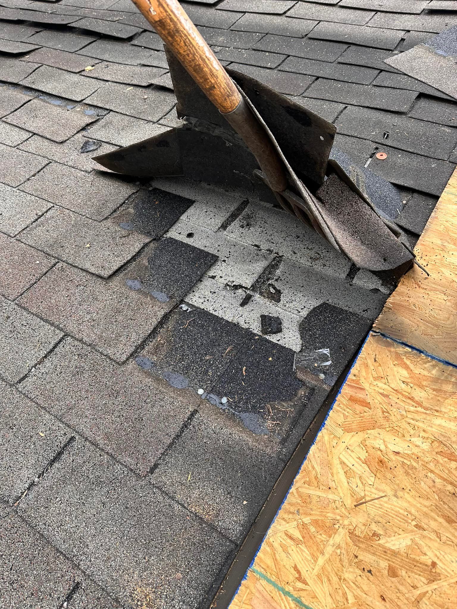 A shovel is laying on top of a roof.