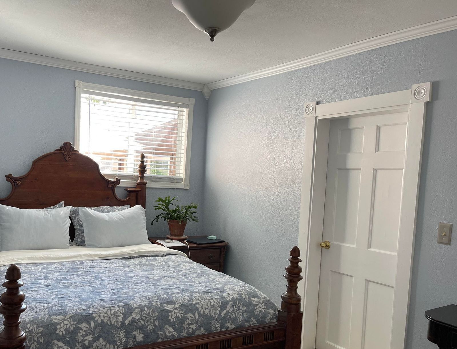 A bedroom with a king size bed and a window