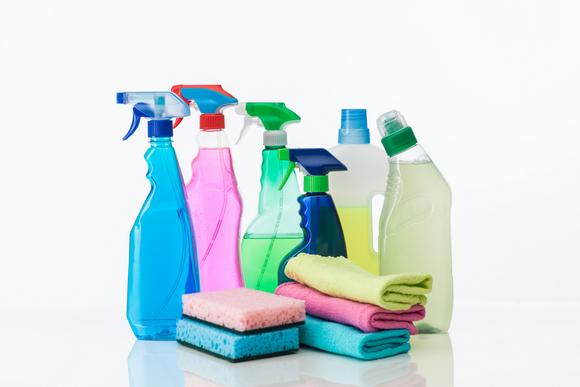 A group of cleaning supplies including spray bottles , sponges , towels and cloths.