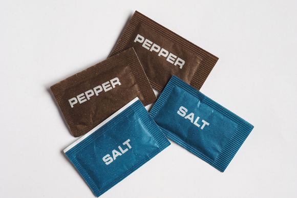 Three packets of pepper salt and pepper are stacked on top of each other