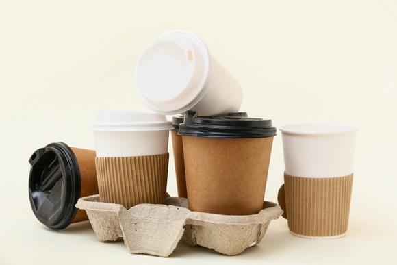 A group of coffee cups stacked on top of each other on a table.