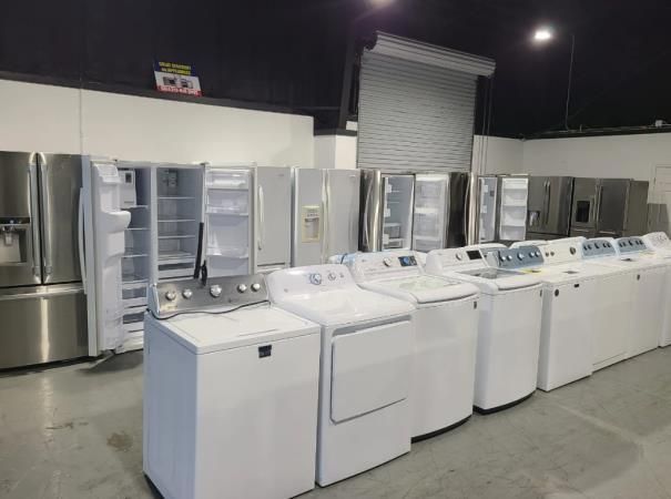 A kitchen with a stove , microwave , sink and dishwasher.