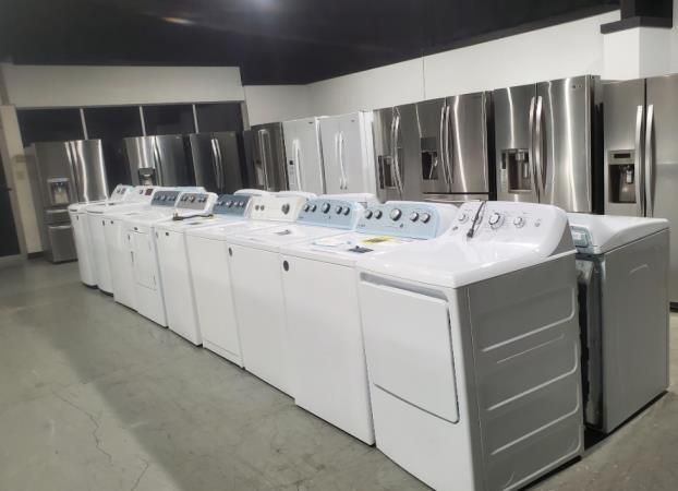 A kitchen with a stove , microwave , sink and dishwasher.