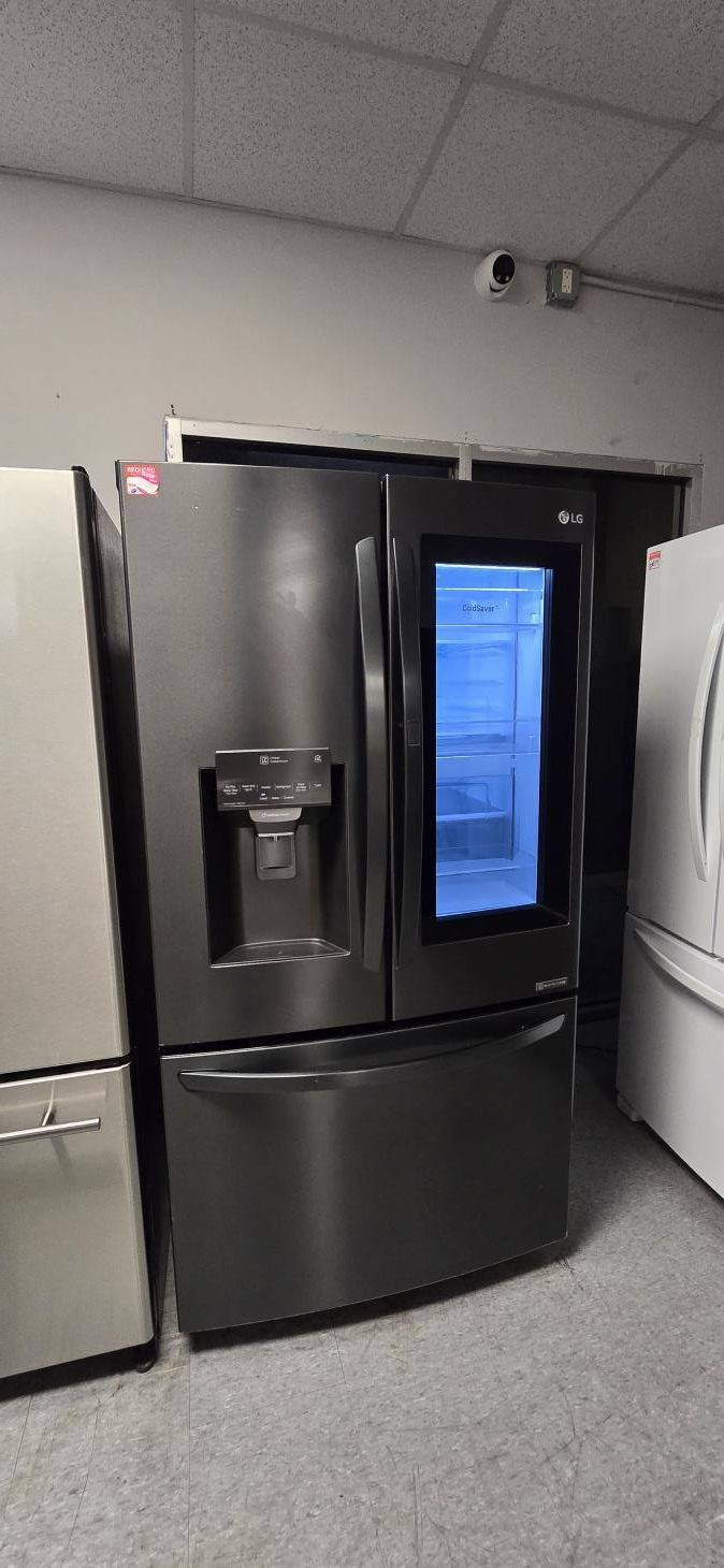 A kitchen with a stove , microwave , sink and dishwasher.