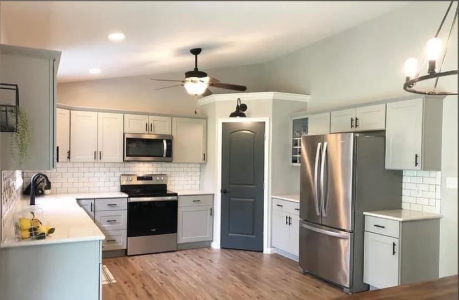 A kitchen with stainless steel appliances and white cabinets