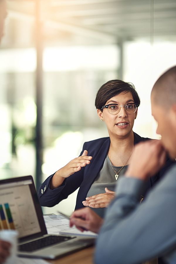 CPA explaining client's financial data shown on her laptop