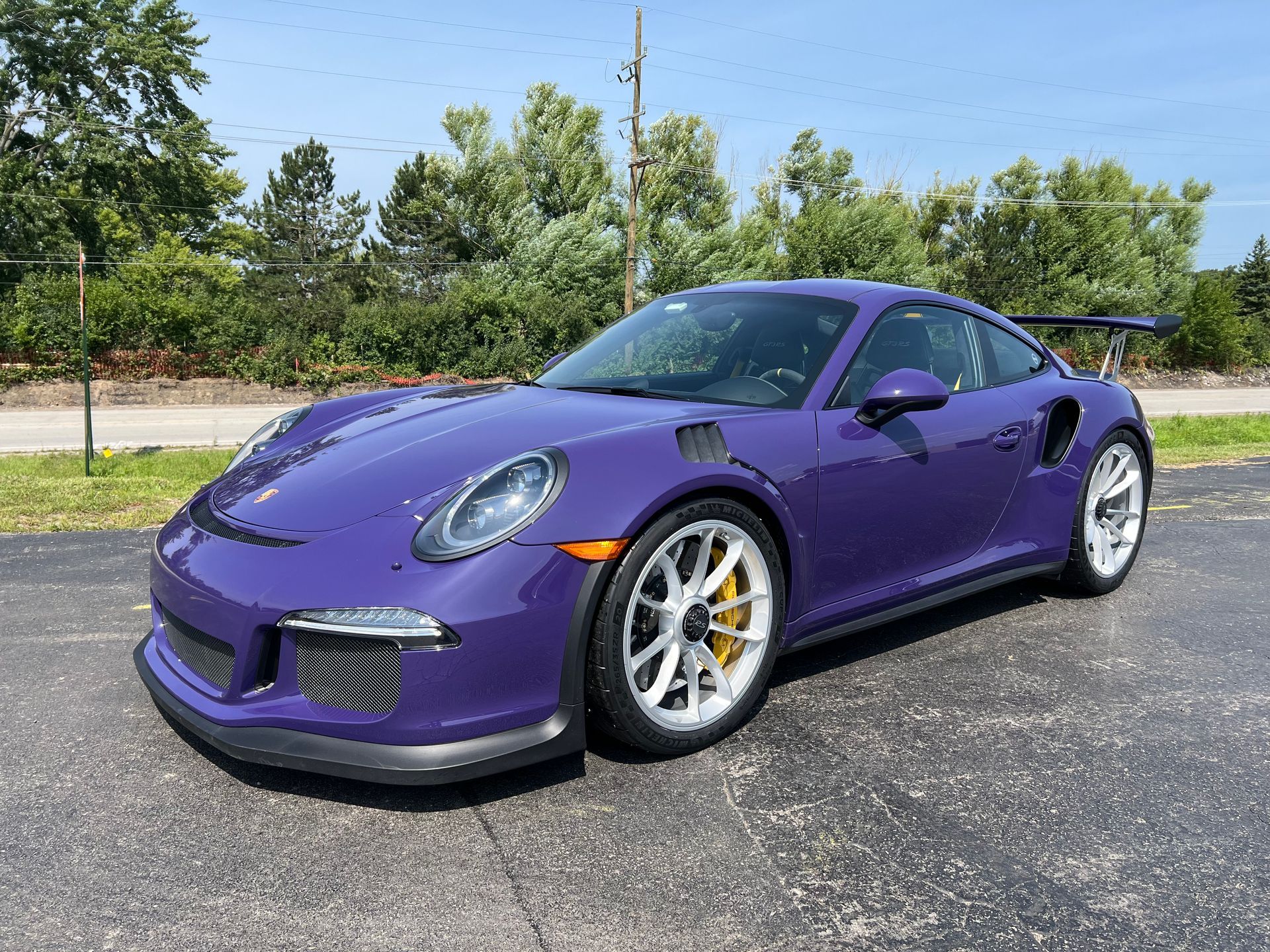 Black Mercedes-Benz sedan, parked on asphalt. Shiny black paint reflects the surroundings. Chrome accents.