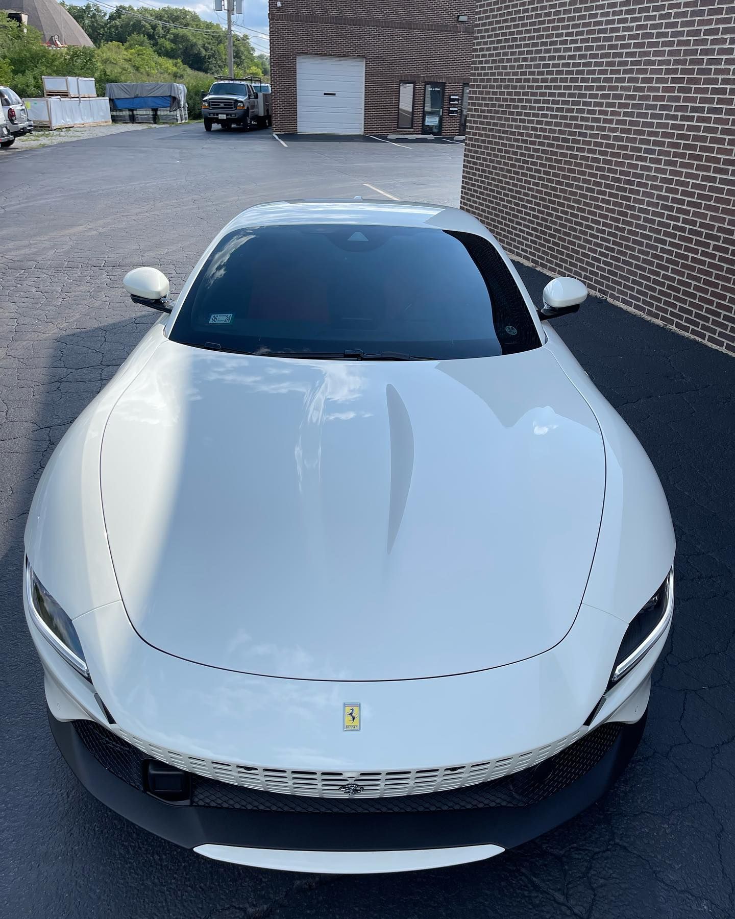 White Ferrari sports car parked outdoors.