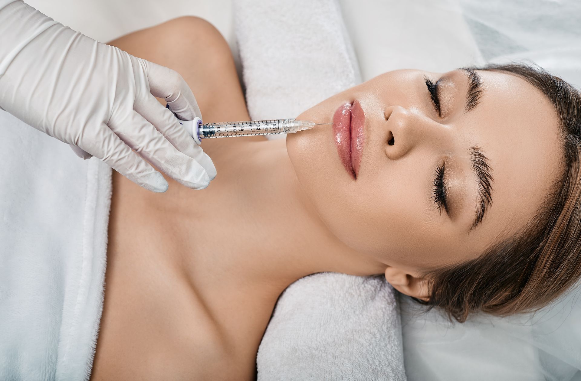 Eine Frau bekommt eine Botox-Injektion ins Gesicht.