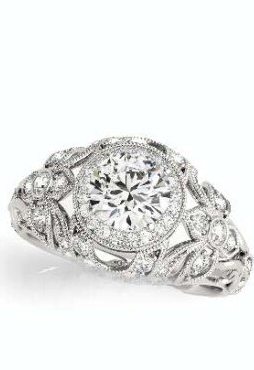 A white gold ring with a diamond in the center on a white background.