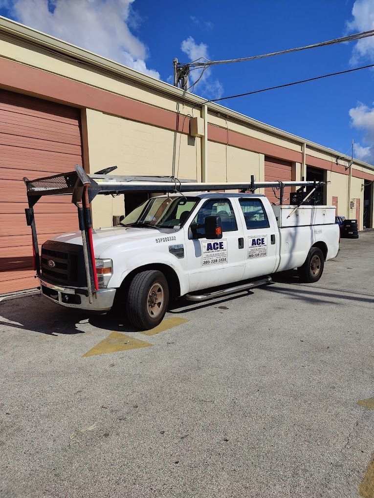 A white truck is parked in front of a building.