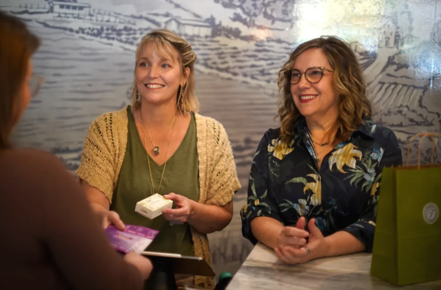Owners Loren and Paula assisting a customer check out in Franny's Farmacy Raleigh