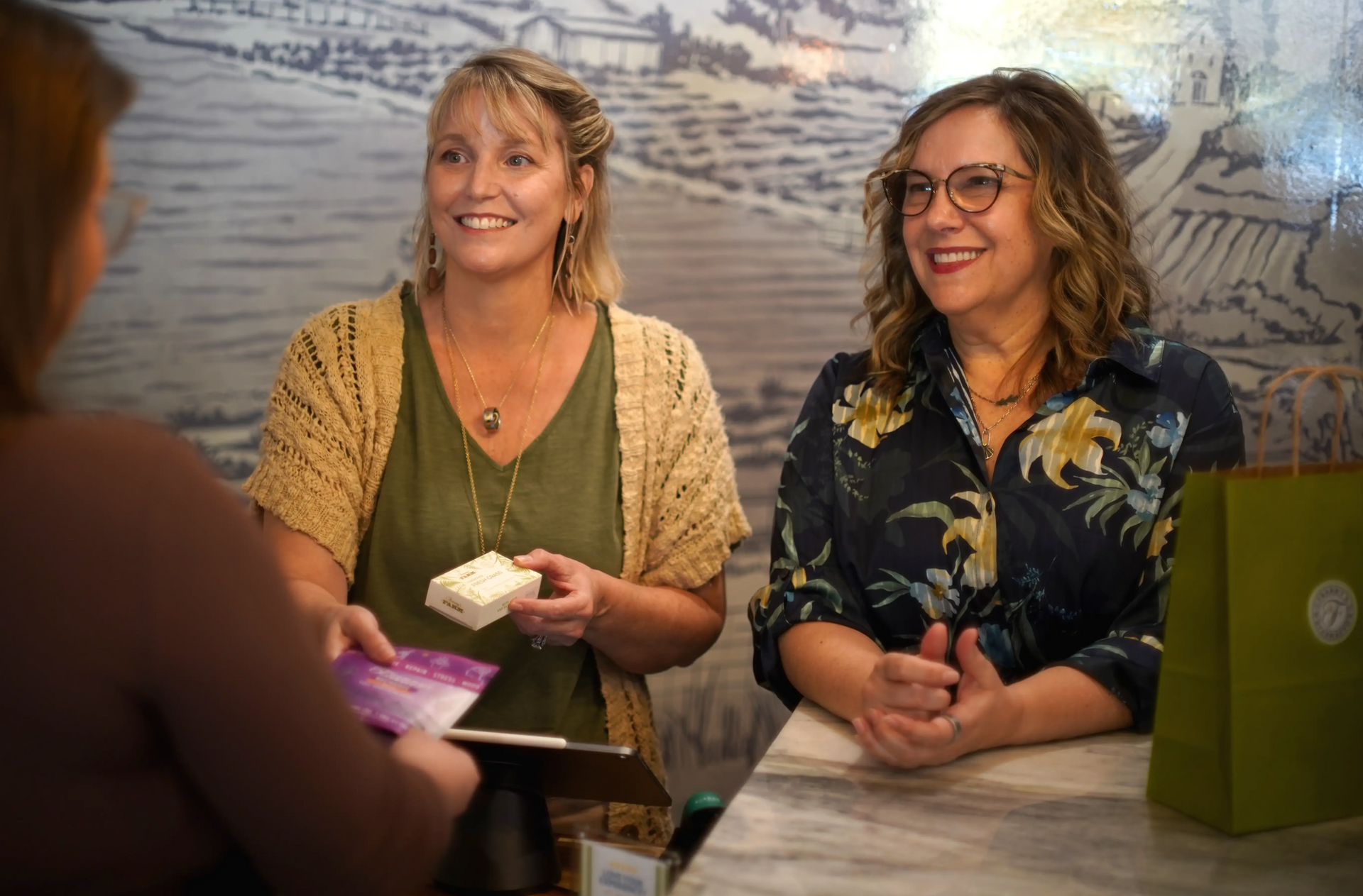 Owners Loren and Paula assisting a customer check out in Franny's Farmacy Raleigh