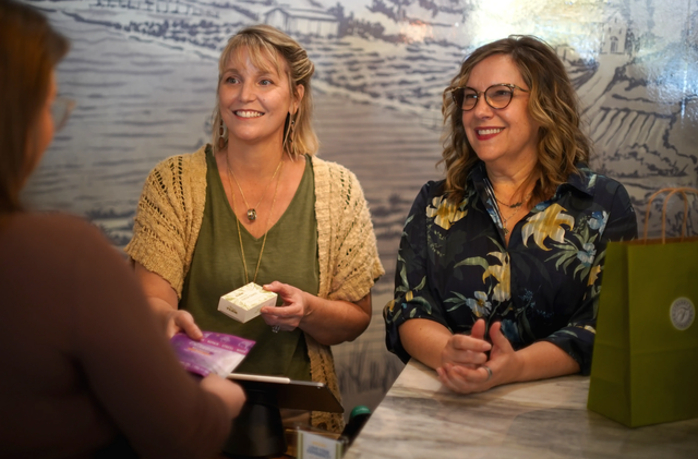 Owners Loren and Paula assisting a customer check out in Franny's Farmacy Raleigh