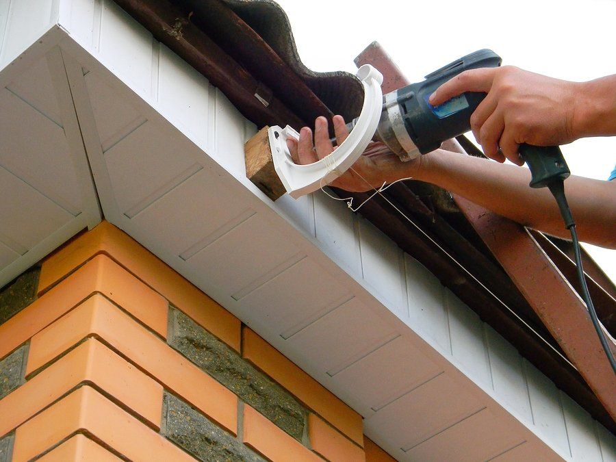 worker installing commercial gutters