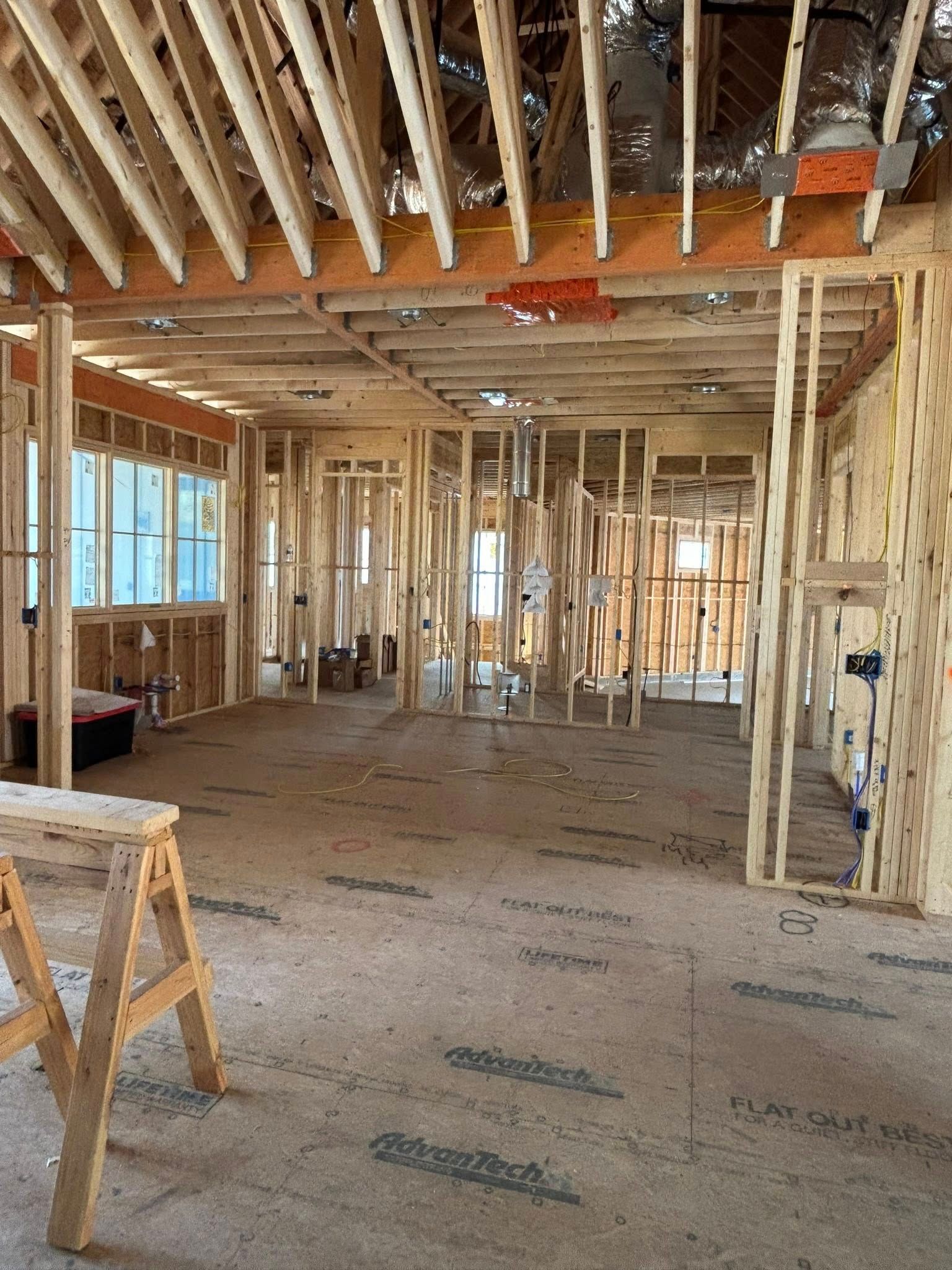 The inside of a building under construction with a wooden trestle in the middle of the room.