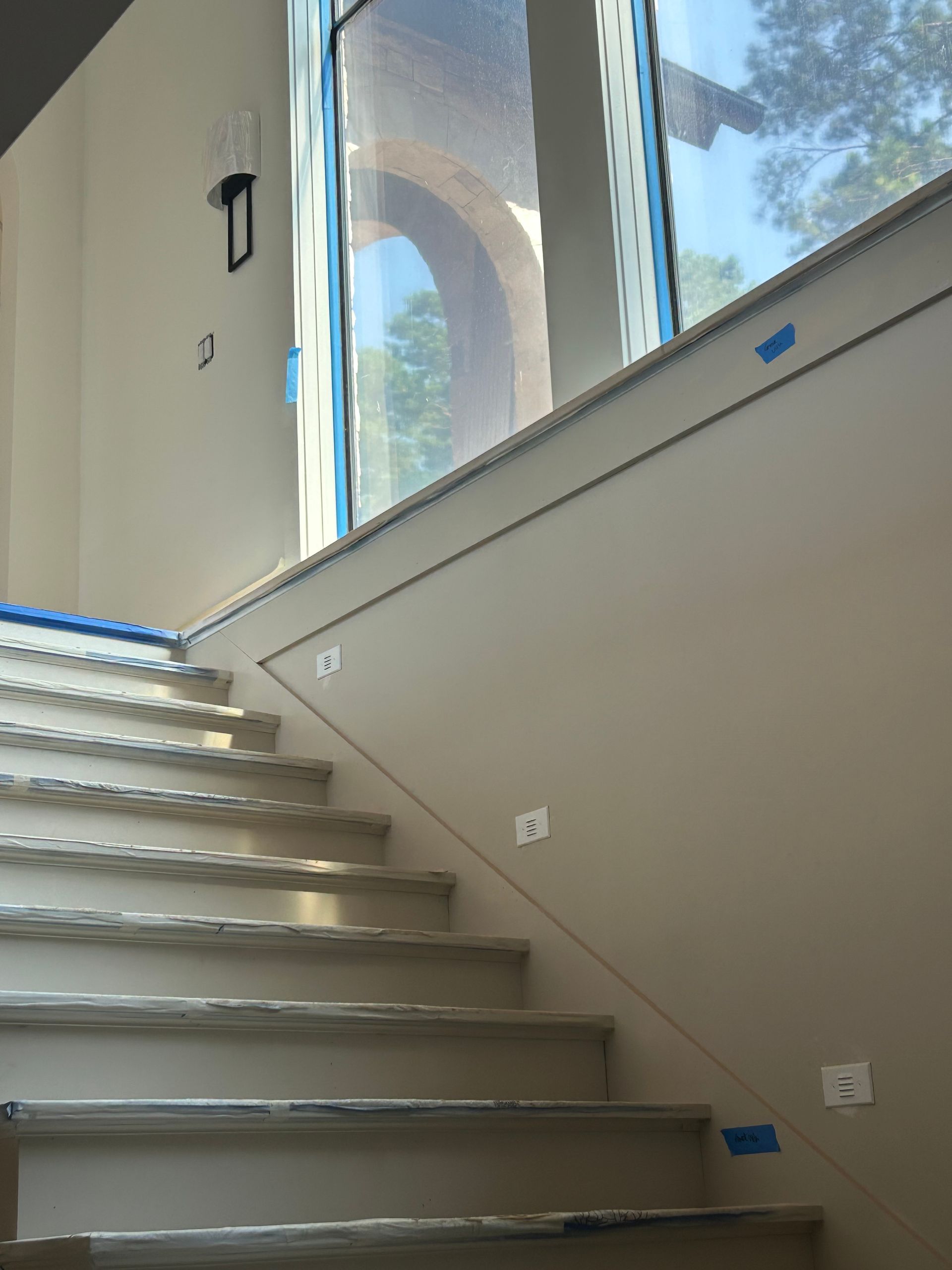 A set of stairs with a window in the background