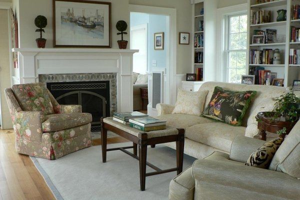 A living room with a couch and chairs and a fireplace