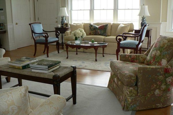 A living room with a couch and chairs and a coffee table
