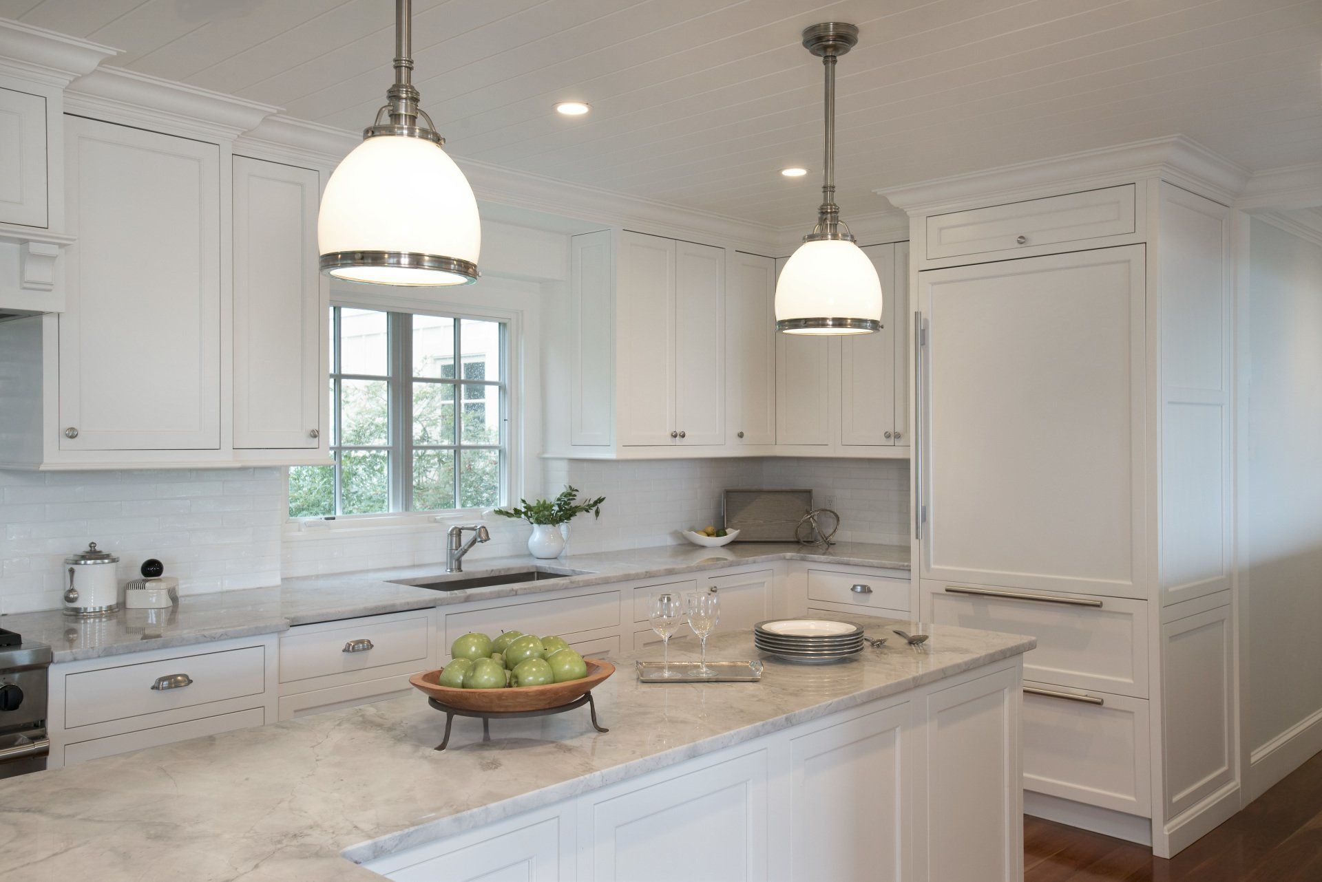 A kitchen with white cabinets and granite counter tops