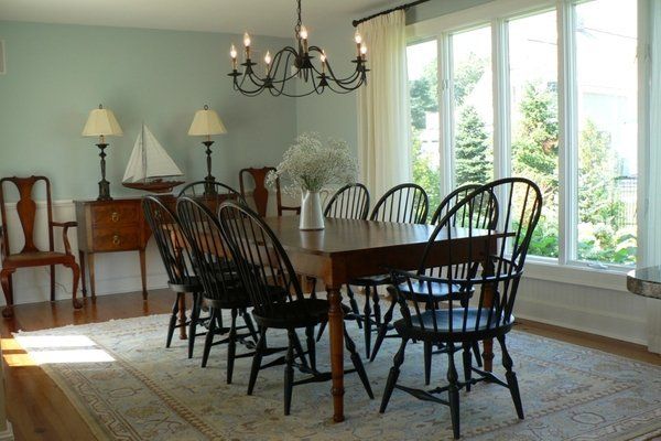 A dining room with a long table and chairs
