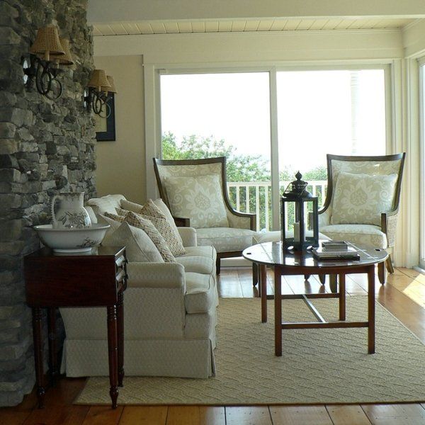 A living room with a couch and chairs and a table