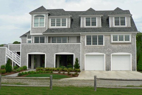 A large house with a fence in front of it