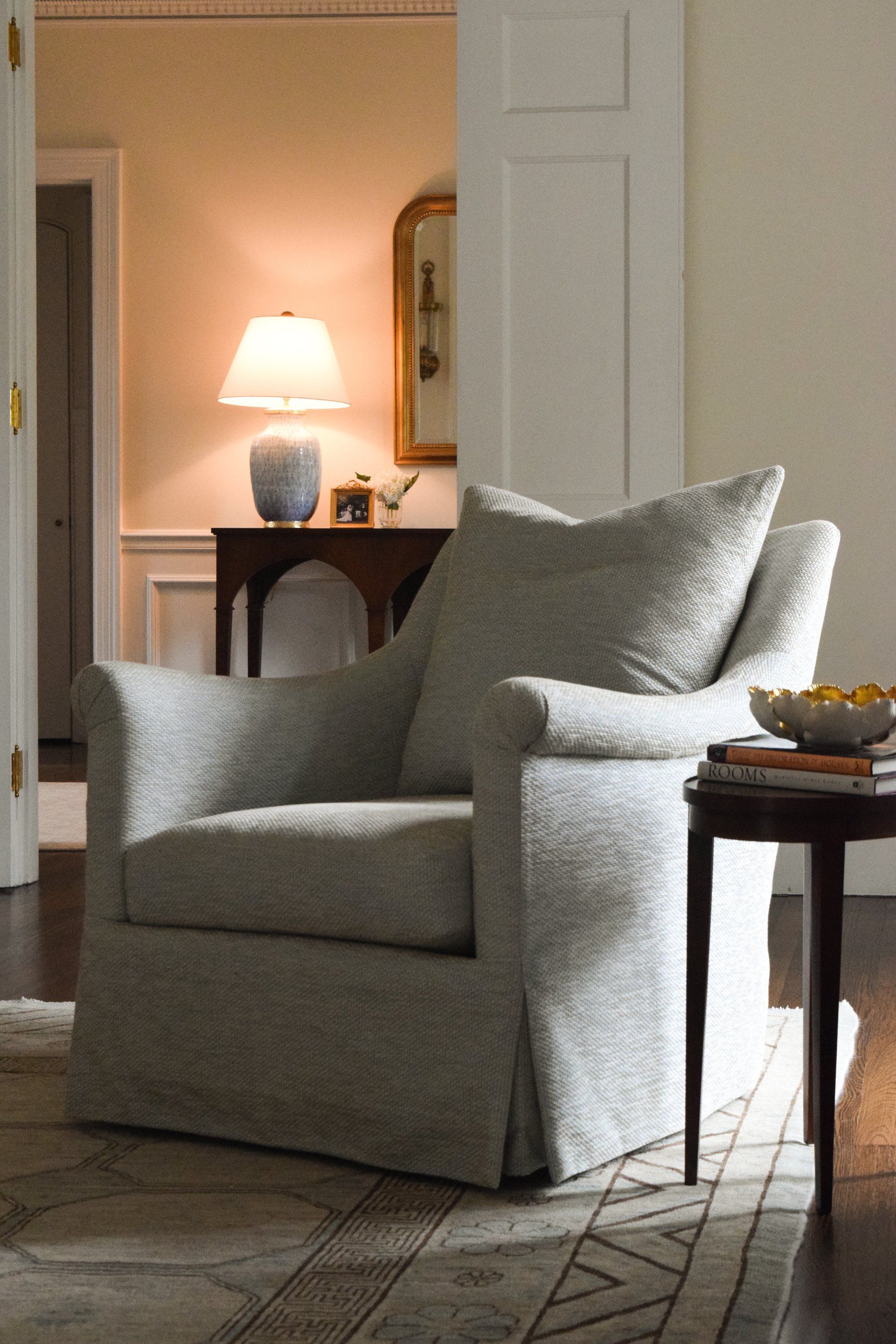 A living room with a chair and a lamp