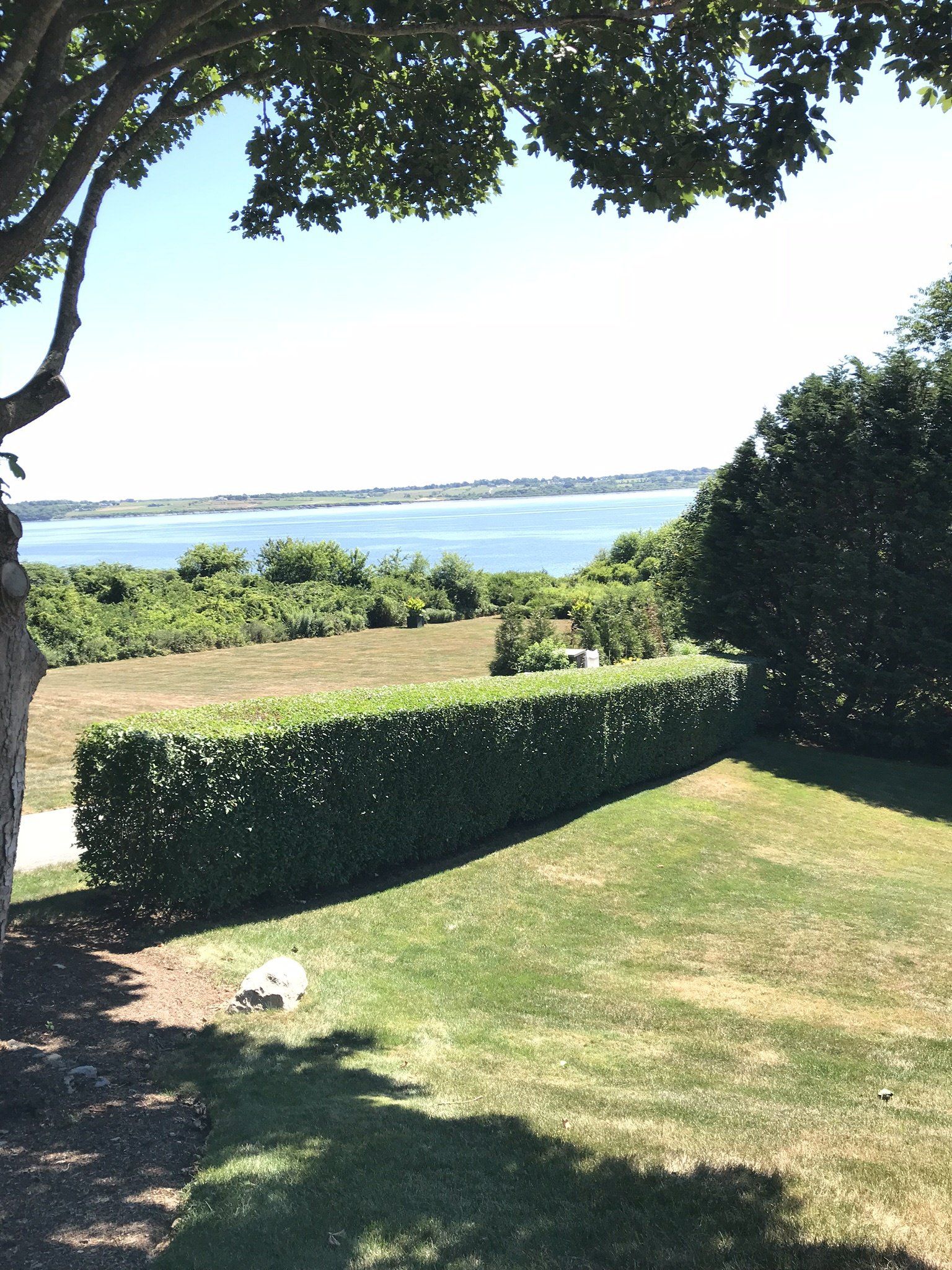 A view of a body of water from the backyard of a house