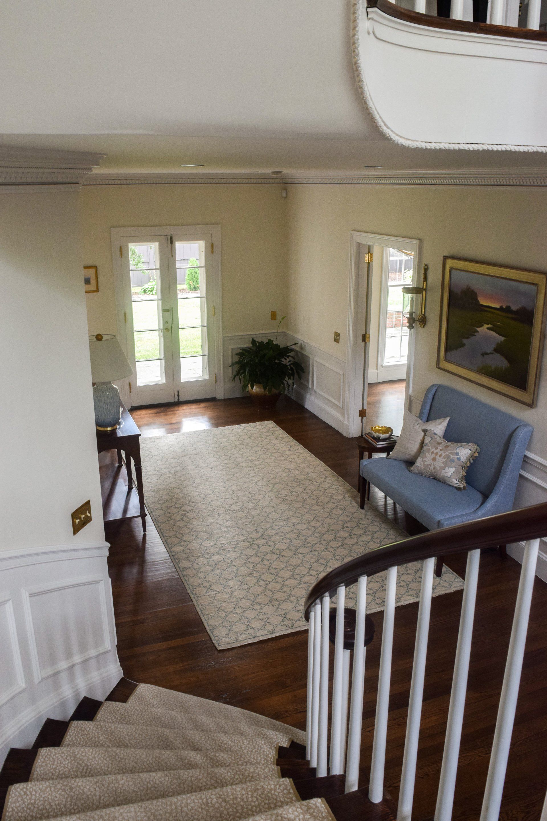 A view of a living room from the top of a spiral staircase.
