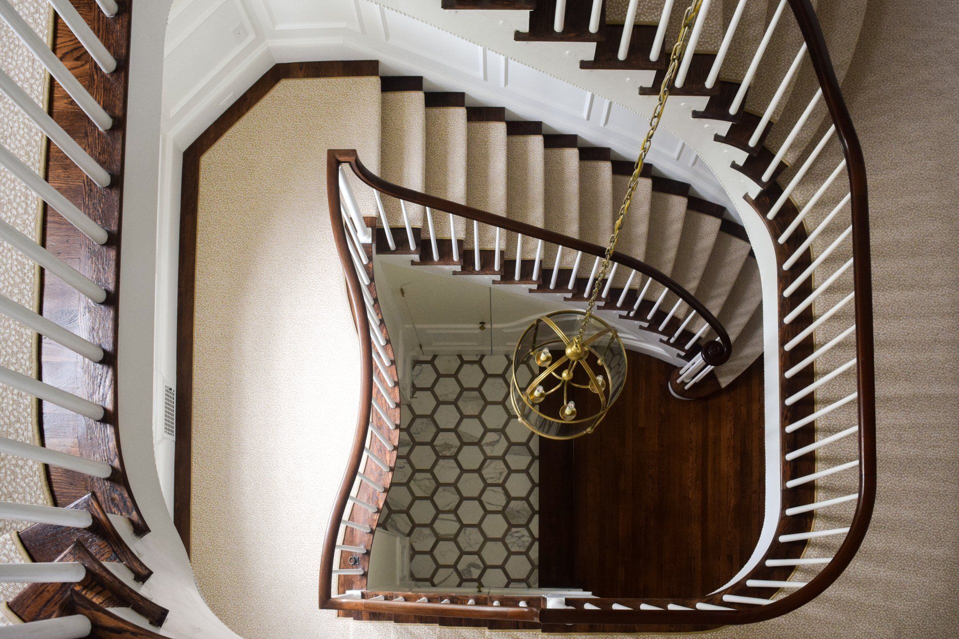 An aerial view of a spiral staircase in a house