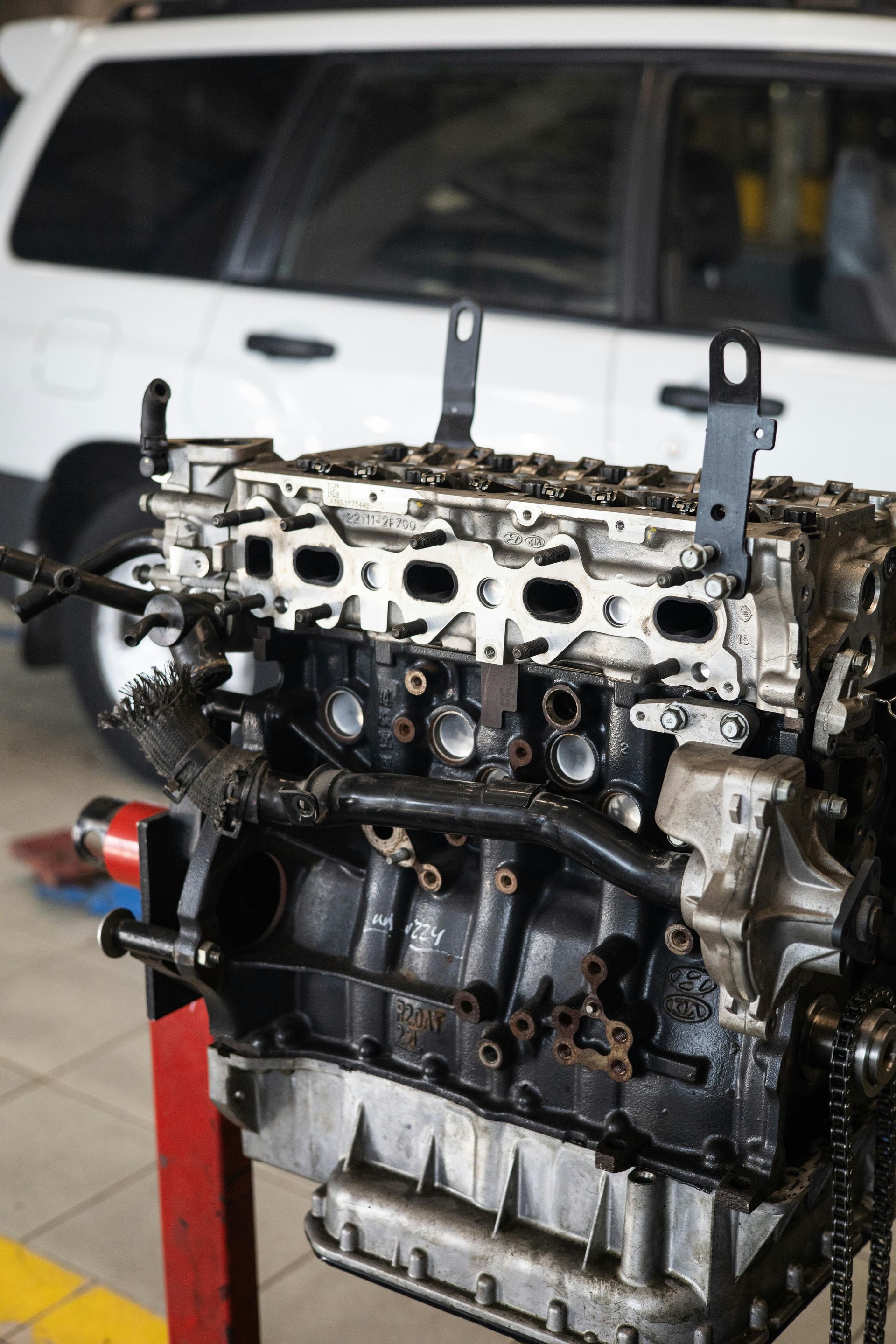 A car engine is being worked on in a garage.