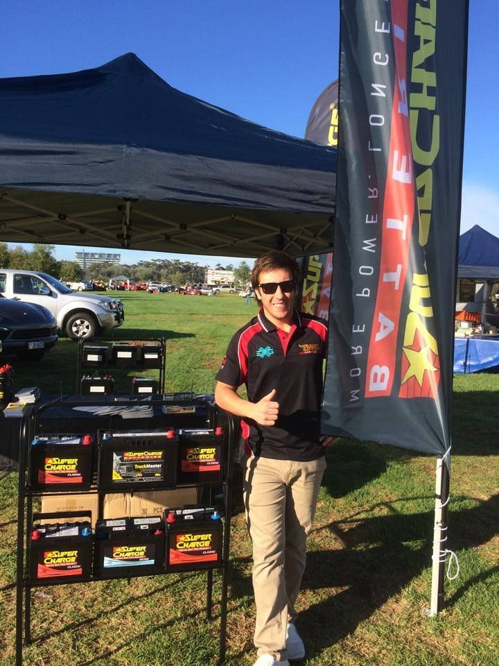 Man Holding Super Charge Banner — Ridgehaven, SA — Modbury Battery Service Pty Ltd