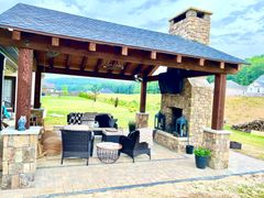 There is a fireplace in the middle of the patio area.