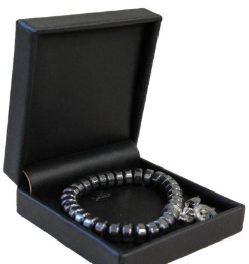 Zwarte armband met bedel in een zwart sieradendoosje.