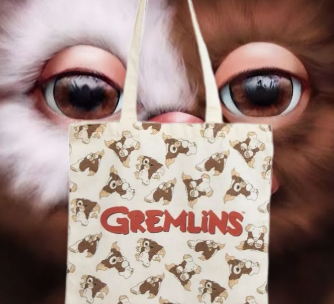 Draagtas met een Gremlins-patroon, met een afbeelding van een Gremlin-gezicht, in bruin en wit.