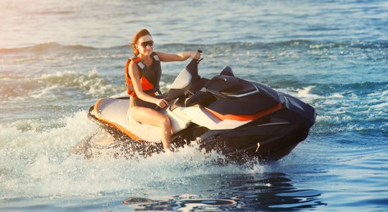 a woman is riding a jet ski on the lake
