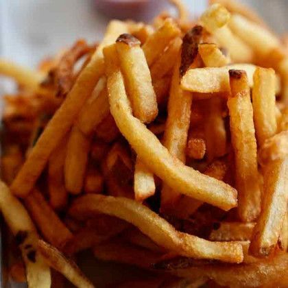 A close up of a pile of french fries